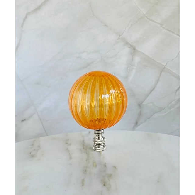 Oversized glass lamp finial crafted from a handblown glass bubble. Each has a vertical striped pattern and a ribbed...