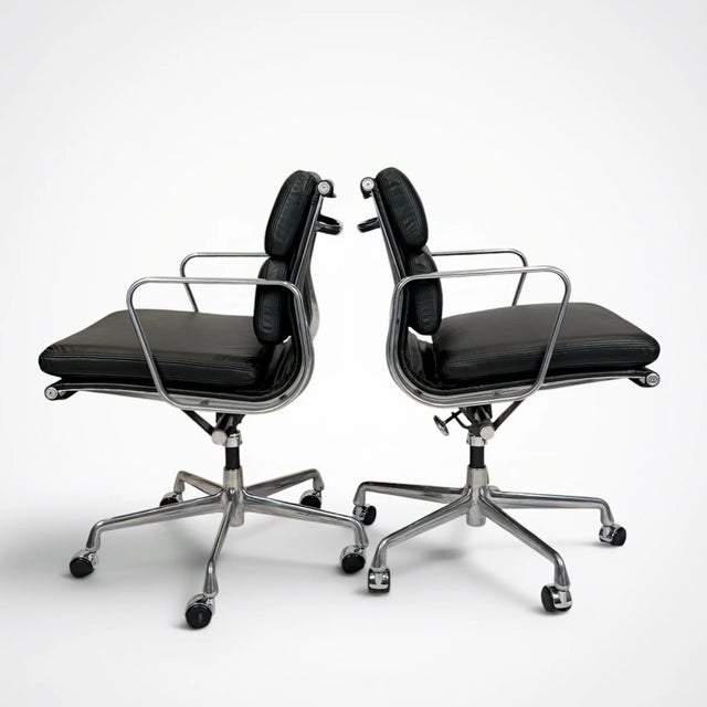 A beautifully restored pair of Eames Aluminum Group Soft Pad Management Chairs, originally designed by Charles and Ray...