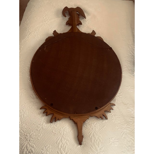 Regency Federal convex gilt mirror with ebonized trim. The glass has a convex shape, so it bends outward and will capture...