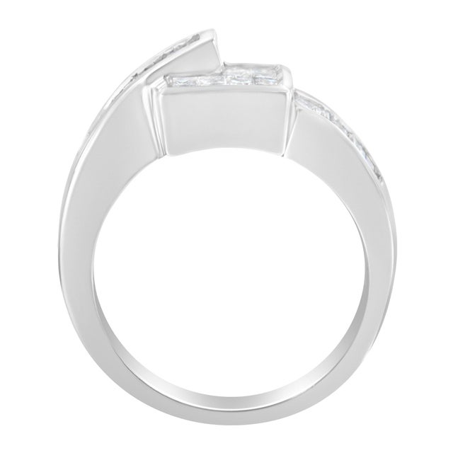 This beautiful 14 karat white gold overlay ring has princess and baguette shaped diamonds set up in the channel form...