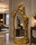 Make an unforgettable statement with this extra-large sculptural gold floor mirror, designed to function as both a...