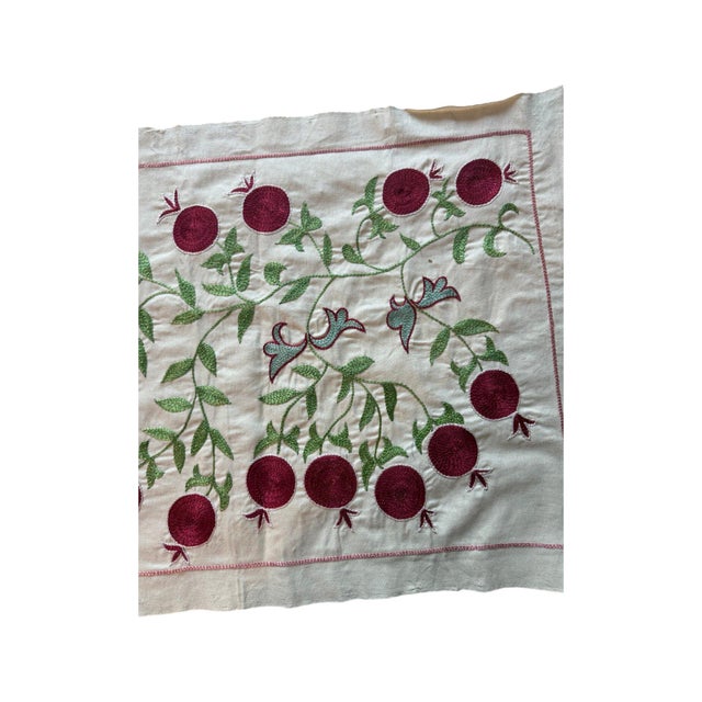 Hand-embroidered Suzani panel from Uzbekistan, worked in fine floss on a cream cotton ground. Two pink winged horses move...