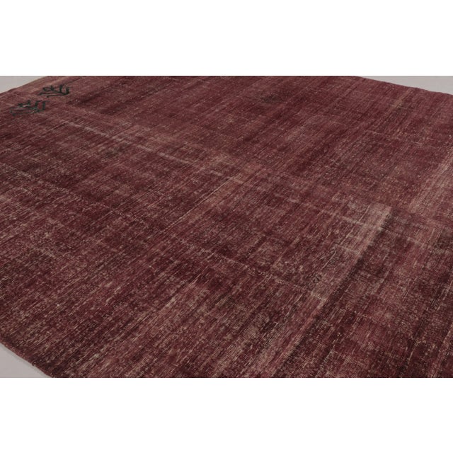 This vintage rug is a 10x12 Turkish distressed piece, made with hand-knotted wool circa mid-20th century. It is an...