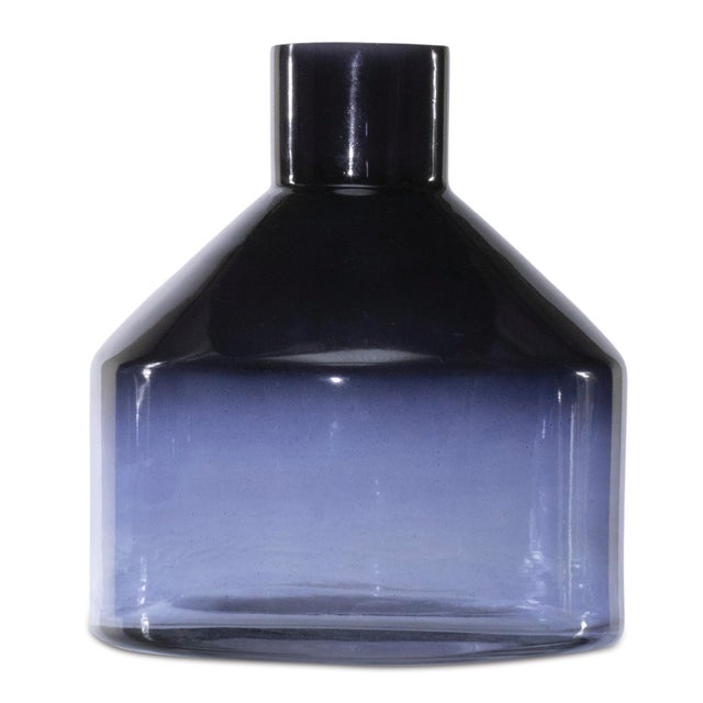 Bring a splash of serene style to your space with this Blue Soda Lime Glass Bottle Vase. Standing 6 inches tall, its...