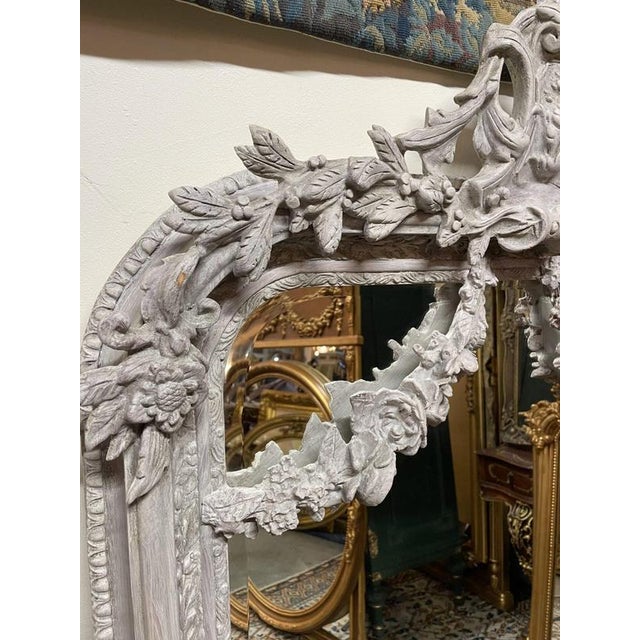 Beautiful painted French-style mirror available. Ornate gilt frame with detailed decoration throughout, finished with a...