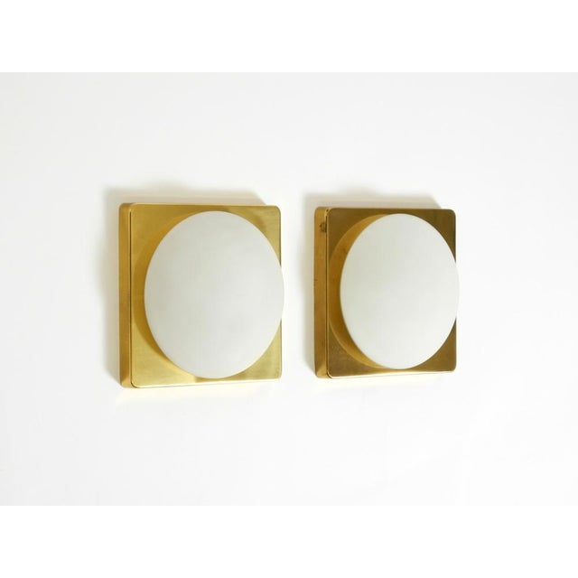 Two square brass wall lamps from the 1970s. designed by rolf krüger for the manufacturer heinz neuhaus leuchten, germany....