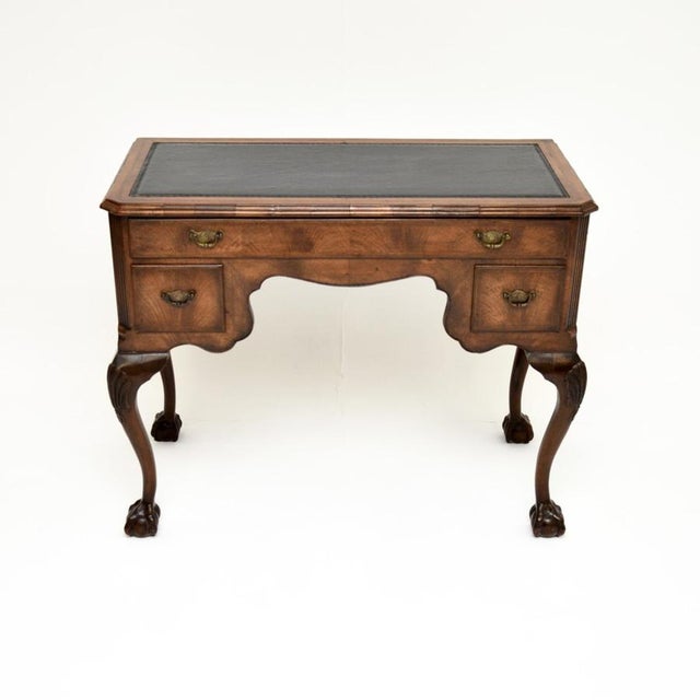 A superb antique figured walnut leather top desk. This was made in England, it dates from around the 1900-1910 period. The...