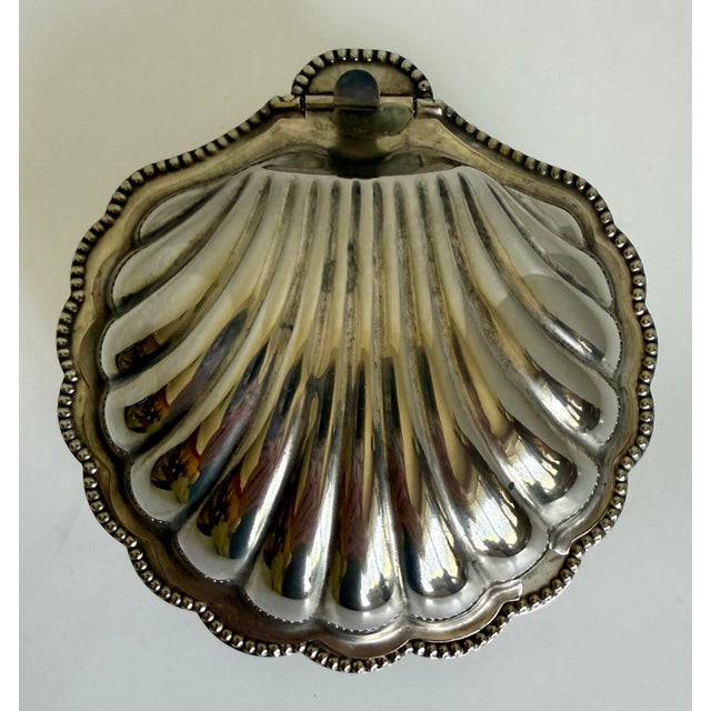 Here is a circa 1920s English silver-plated clamshell butter dish by E & J Leek. Beautifully sculptural, the hinged dish...