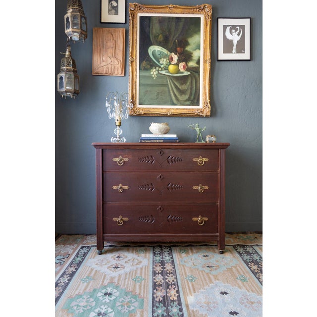 This newly refinished antique chest of drawers features Eastlake inset carvings in a simple, floral folk style, and...