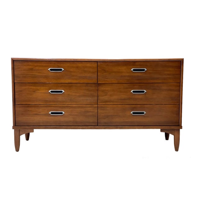 This vintage Mid-Century Modern lowboy dresser by Drexel features a clean, architectural case design with a warm walnut-...