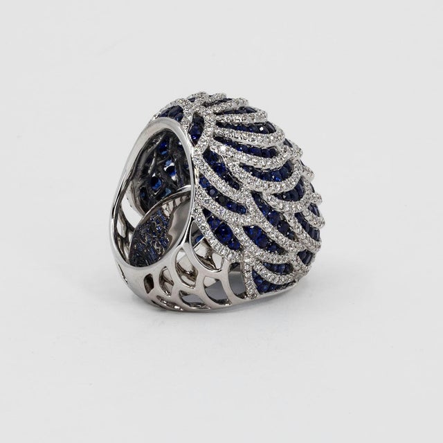 18k White Gold Ring with 457 round diamonds weighing 2.90 carats and 185 Blue Sapphires weighing 7.50 carats. 33.99 grams.