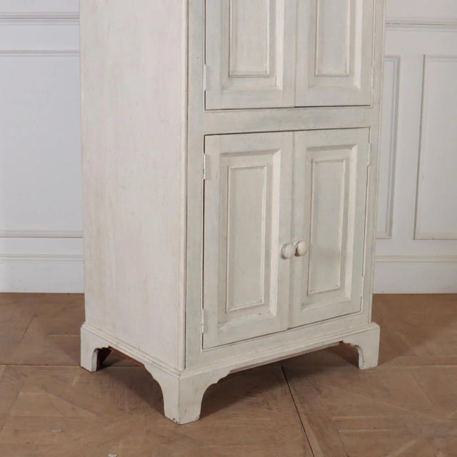 19th C English painted pine four door shelved linen cupboard. 1890. This piece is designed in the style of the selected...