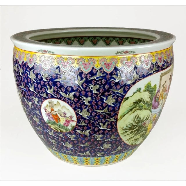 A giant 26" Diameter Famille Rose Fish Bowl with garden or courtyard scenes.