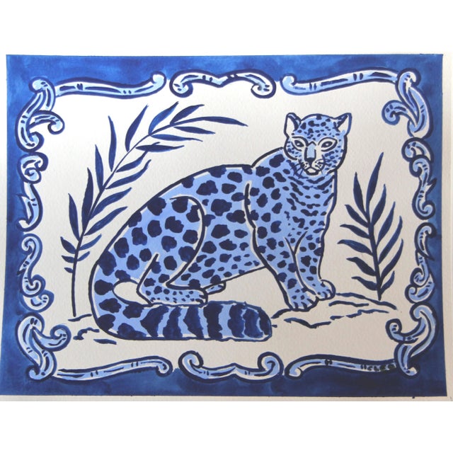 A wild leopard or cheetah surrounded by a Delft tile border pattern, in indigo and cornflower blue on a white background,...