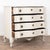 The white painted finish is striking in this attractive large chest of four drawers resting on a decoratively carved skirt...
