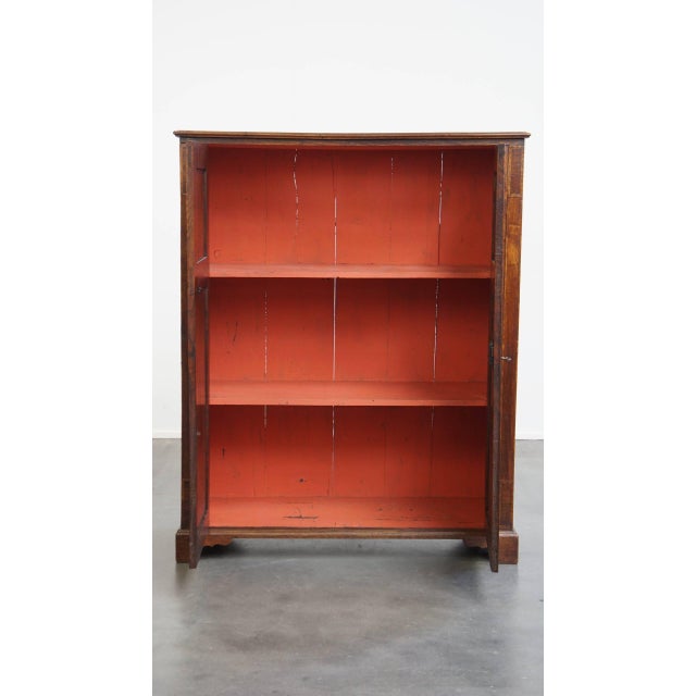 Offered is this beautiful, characterful antique English 2-door cabinet from the 18th century with intarsia inlay. This...