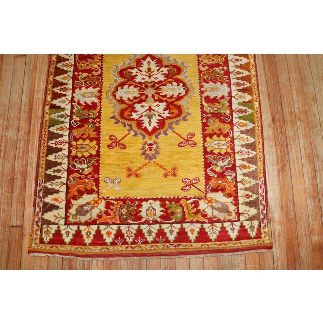 An authentic Turkish Melas rug featuring a bright yellow field. 3'3'' x 4'8''