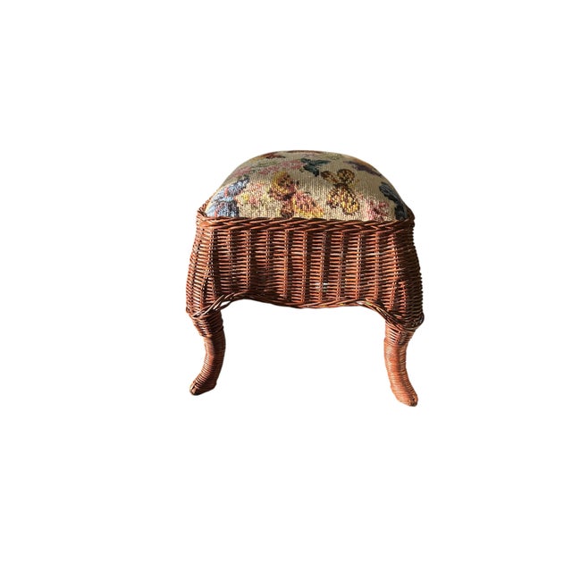 A wonderful vintage wicker footstool with a needle point top filled with expertly stitched florals and butterflies. The...