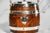 Offered here is a delightful English antique biscuit barrel, beautifully crafted with an oak wood exterior and a porcelain...