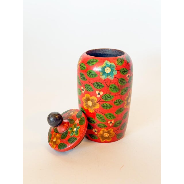 Charming little lidded wooden jar with lid, hand painted red with floral motif. Great bookcase accessory or chic place to...