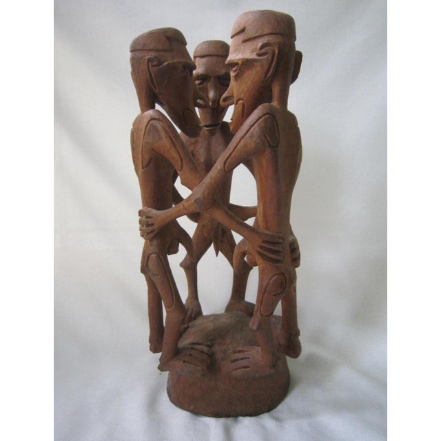 Extraordinary carved wood sculpture of African Tribal Males. Highly detailed on every aspect of the figures. The sculpture...