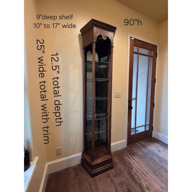 Great looking tall narrow open display with glass shelves and smokey mirrored back. Each shelf has a carved notch for...
