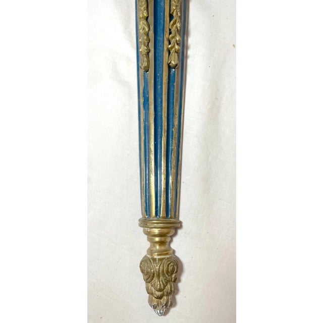 This antique wall candle holder is a stunning example of Neoclassical style. Crafted from bronze, this sconce boasts...