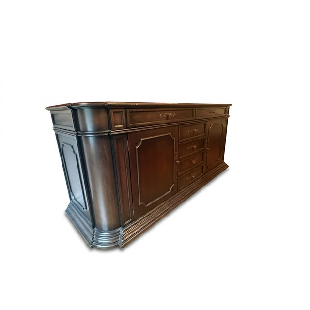 An impressive, large-scale traditional dining room buffet sideboard featuring bowed curved ends, molded top edging, and...