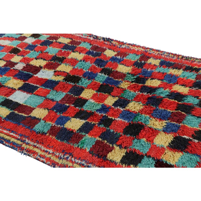 Hand-knotted in wool and originating from Morocco circa 1950-1960, this 4x7 vintage Moroccan rug is an extremely rare...