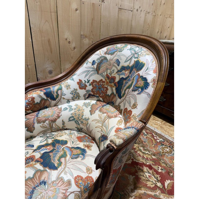 A Louis Philippe period chaise longue, entirely carved from solid walnut. This piece showcases the elegant characteristics...