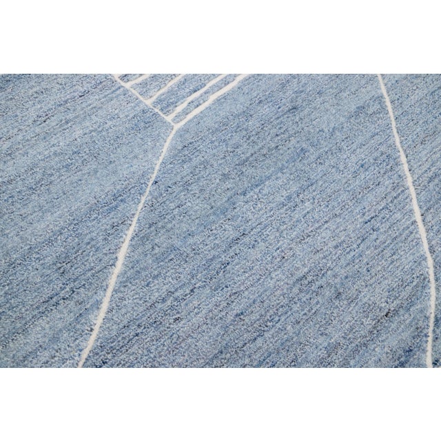 Beautiful modern Moroccan-style hand-knotted wool rug with a light blue color field. This rug is part of our Apadana's...