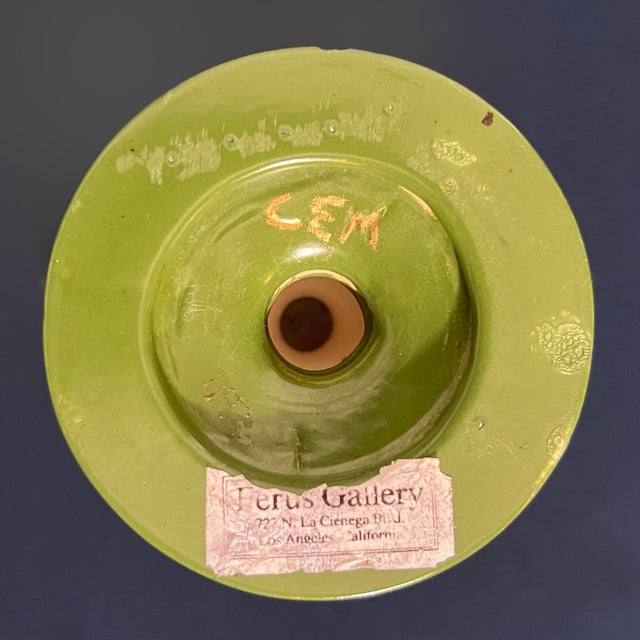 A striking vintage studio art pottery covered urn featuring a rich olive green glaze accented by an expressive cream...