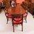 This is an elegant dining set comprising an antique late Victorian three pillar Regency Revival flame mahogany dining...