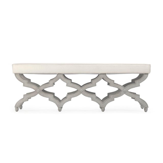 The Judith Bench from Zentique is a French country upholstered bench with a padded off-white linen seat on a distressed...