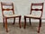 This is a beautiful antique pair of Regency / Duncan Phyfe style dining chairs featuring elegant saber legs, decorative...