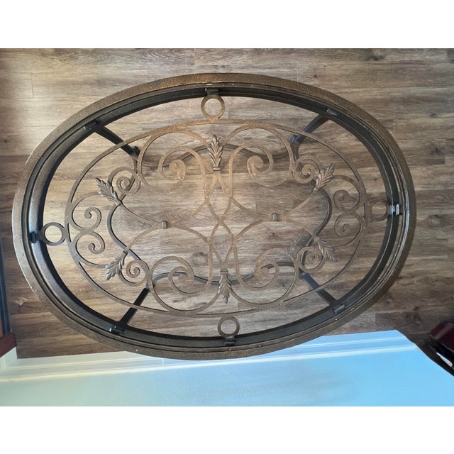- "Antique Bronze" Iron Cocktail Table with intricate, ornate forged designs - 34”x48” oval - Covered by beveled glass top...
