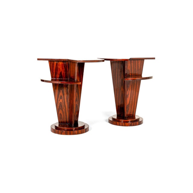 A striking pair of art deco style side tables in a polished english indian rosewood veneer in a macassar style finish. Two...