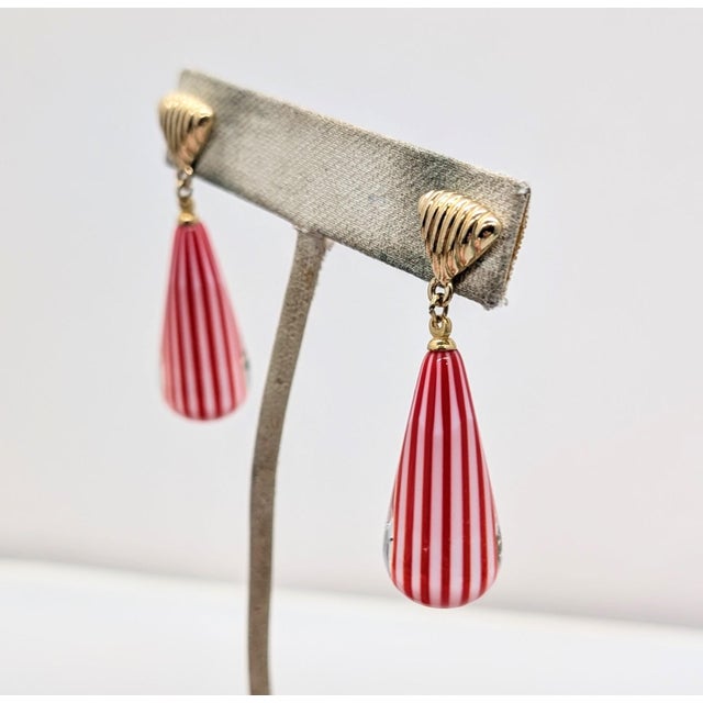 1970s goldtone rounded triangular top with stripes through it and glass drop with red and white stripes pierced earrings....