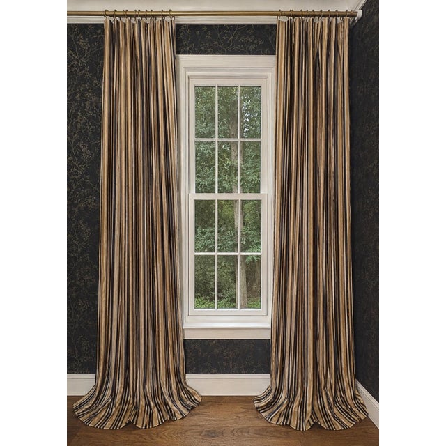 Elegant pair of custom-made drapery panels featuring a sophisticated vertical stripe in black, warm gold, tan, and soft...