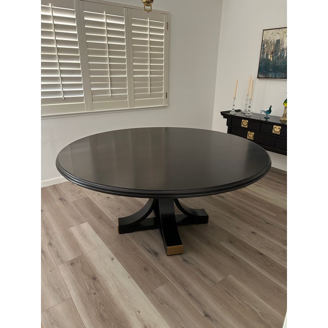 Stunning round Avery dining table by Old Biscayne Designs. The finish is espresso with gold metal on the base.