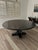 Stunning round Avery dining table by Old Biscayne Designs. The finish is espresso with gold metal on the base.