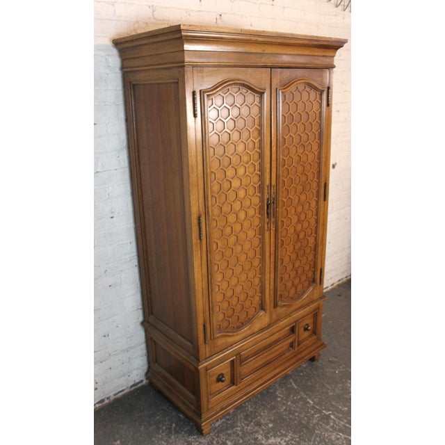 Tall wardrobe by Thomasville for their La Galerie series. Features warm pecan wood with honeycomb front doors. Ample...