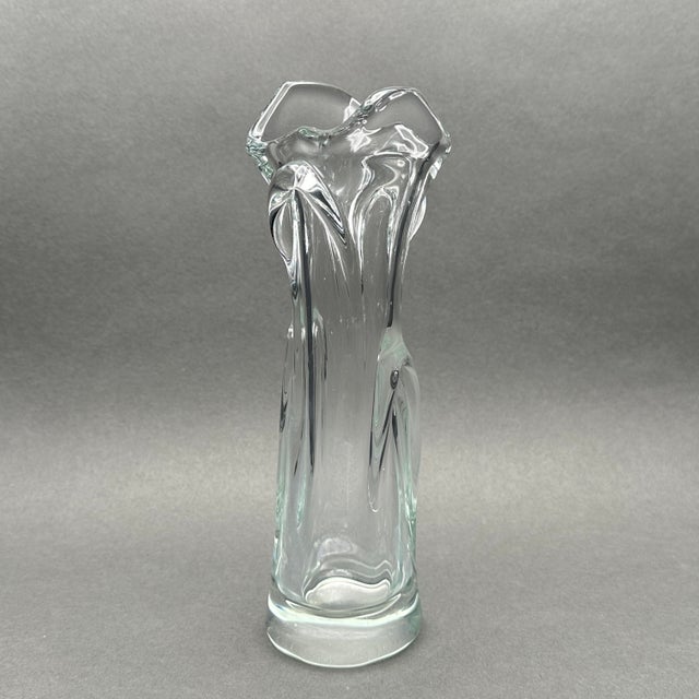 This hand-blown clear glass vase features a unique wavy rim and swung vase design. Ideal for showcasing flowers or as a...