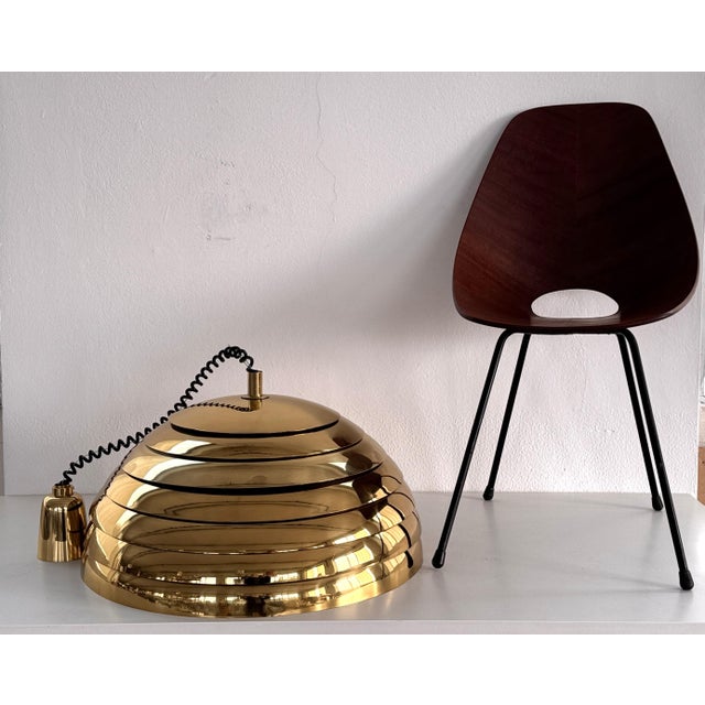 Large and elegant mid-century modern brass pendant chandelier. designed and manufactured by vereinigte werkstätten...