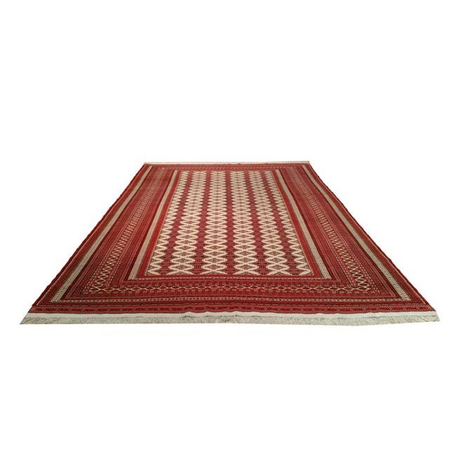 Infuse a touch of beauty to high-traffic areas of your home with this durable Persian turkmen rug in colors of red, white,...