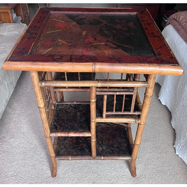 This fabulous Chinoiserie style Aesthetic Movement antique bamboo table features a Cinnabar color painted top and tooled...