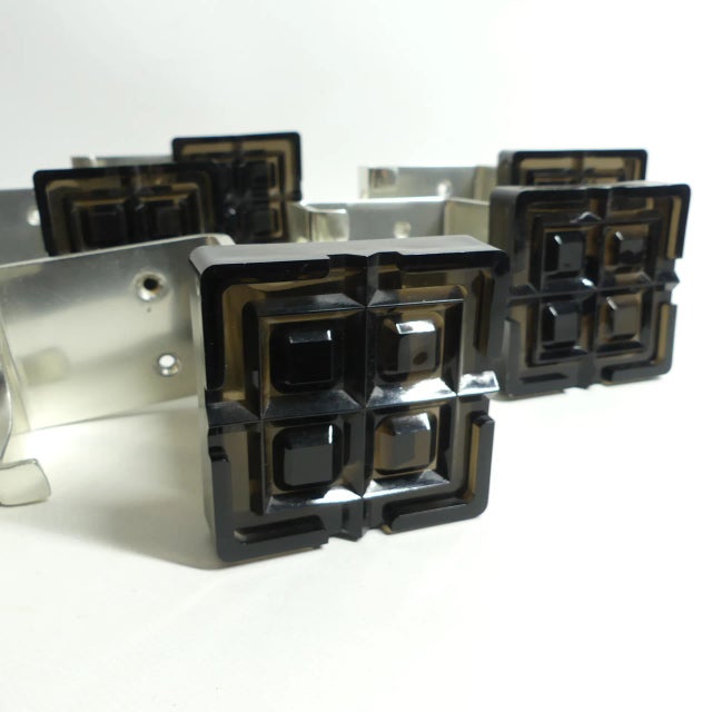 5 Space Age coat hooks from the 1970s Aluminum with a plastic appliqué.