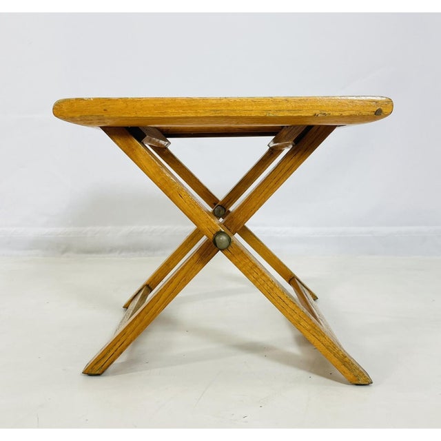 Vintage folding teak stool designed and manufactured by Summit Furniture, renowned for their high-quality teak...