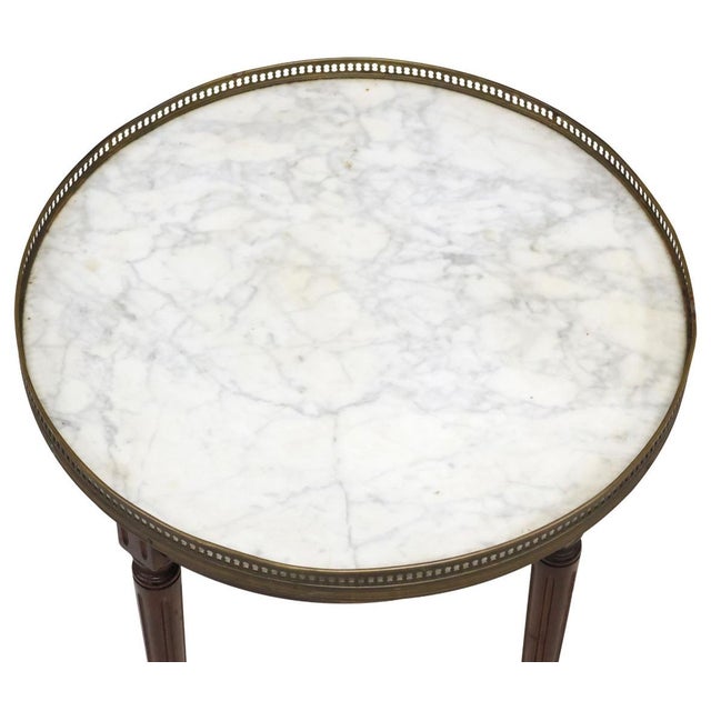 French Louis XVI style bouillotte type side table , 20th c., having inset marble top, encircled by pierced gilt metal...