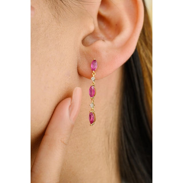 This is part of Chairish’s Fine Jewelry assortment. Minimal Marquise Ruby Diamond Dangle Earrings in 18K Gold to make a...